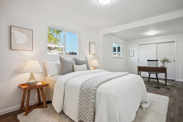 bedroom featuring baseboards and wood finished floors