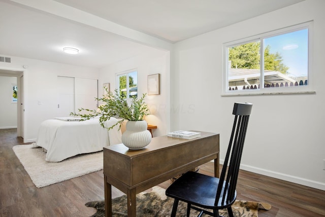 office featuring visible vents, baseboards, and wood finished floors