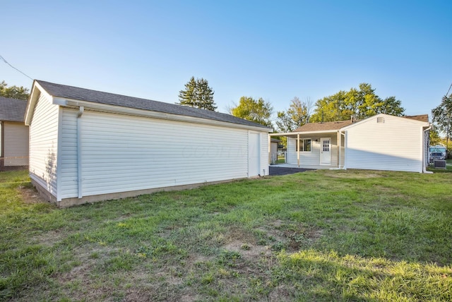 rear view of house featuring a yard