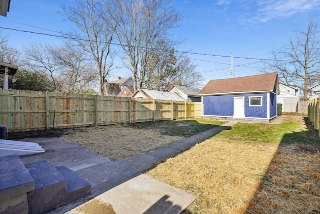 view of yard featuring an outdoor structure and a fenced backyard