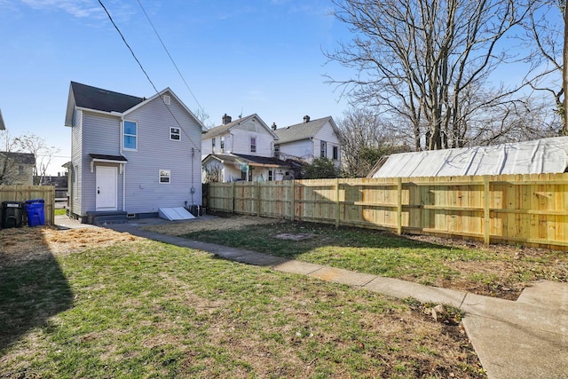 view of yard with entry steps and fence