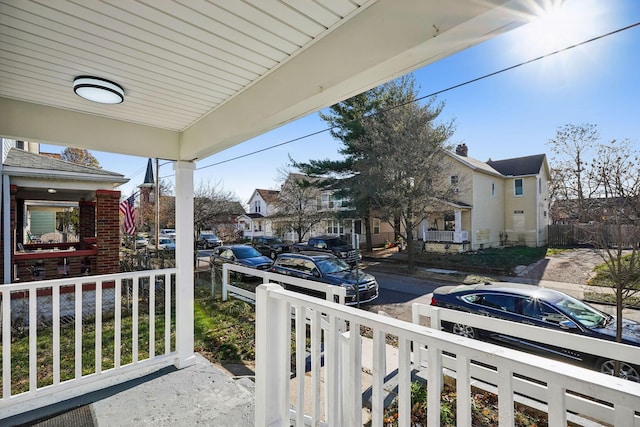 balcony featuring covered porch and a residential view