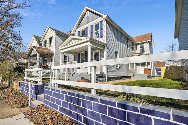 view of side of home featuring a porch and board and batten siding