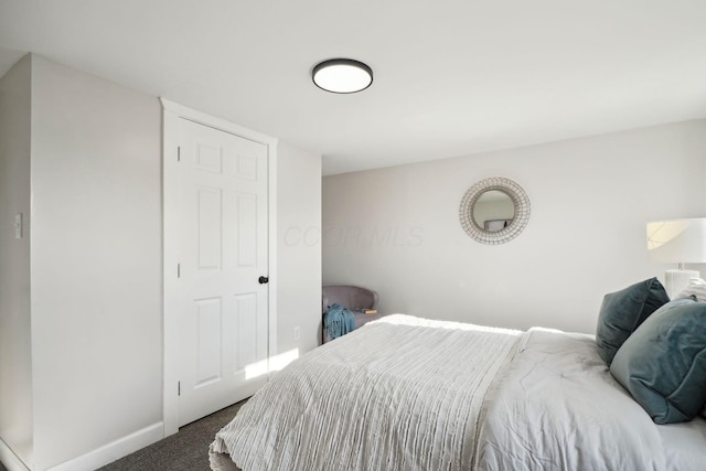 bedroom with baseboards and carpet flooring