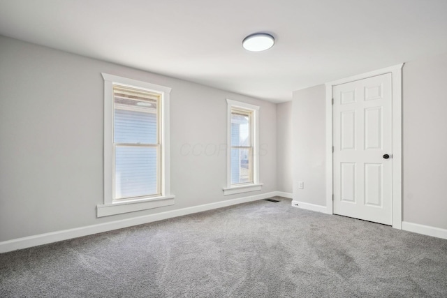 unfurnished bedroom featuring carpet flooring and baseboards