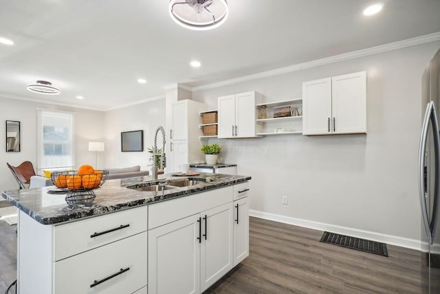 kitchen with open shelves, dark stone countertops, visible vents, and a sink