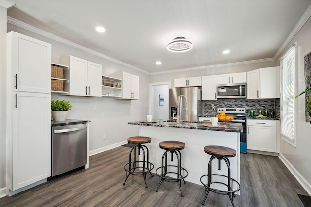 kitchen with a healthy amount of sunlight, appliances with stainless steel finishes, white cabinetry, and open shelves