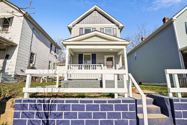 view of front of house featuring stairs, a porch, and board and batten siding