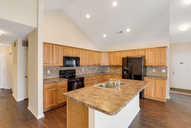 kitchen featuring dark wood finished floors, visible vents, black appliances, and a sink