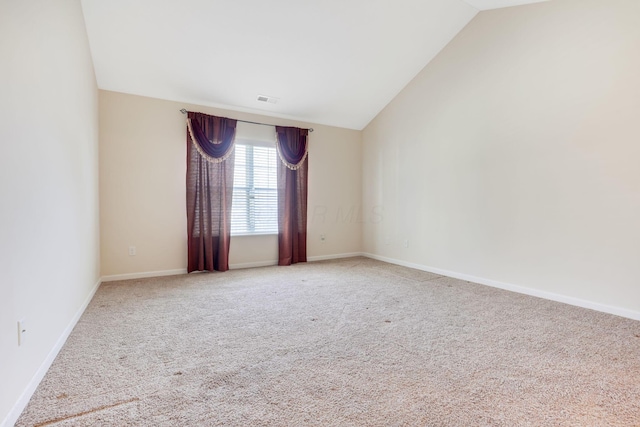 carpeted empty room featuring lofted ceiling, visible vents, and baseboards