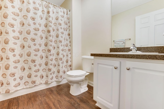 full bath featuring vanity, toilet, and wood finished floors