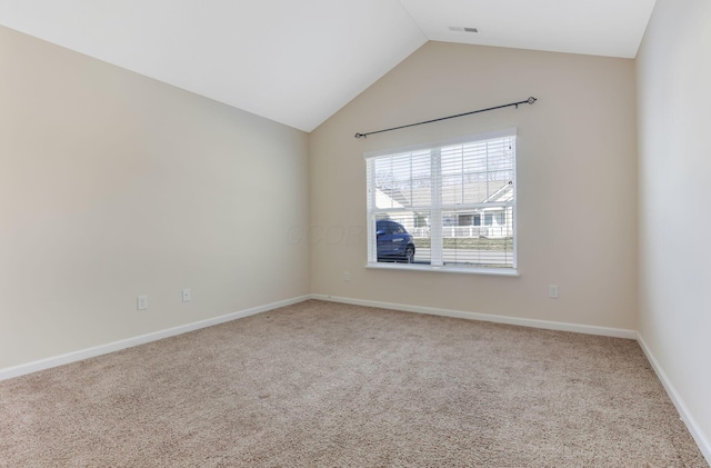 empty room featuring lofted ceiling, baseboards, visible vents, and carpet floors