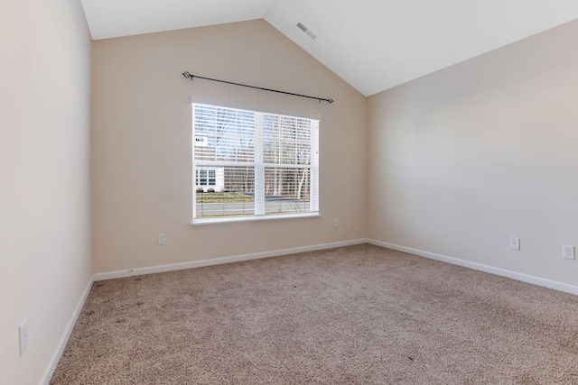 carpeted empty room featuring vaulted ceiling, visible vents, and baseboards