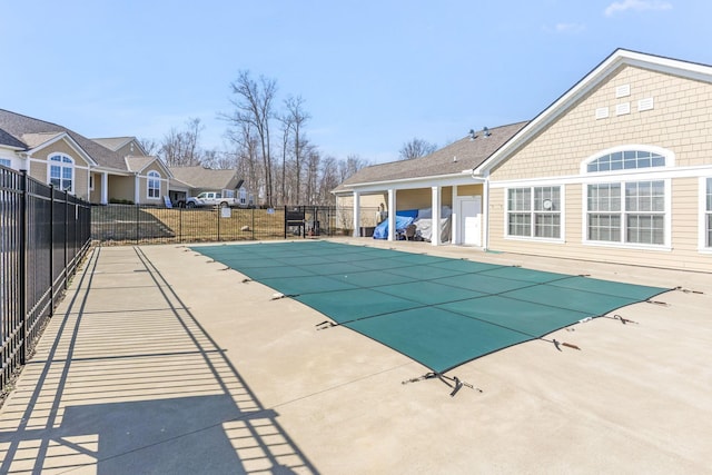 view of swimming pool with a patio area, a fenced in pool, and fence