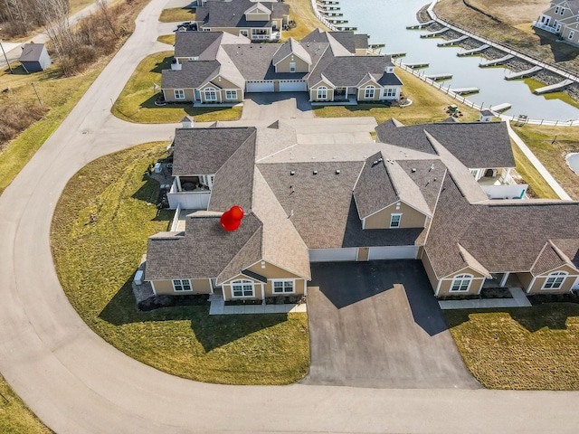 bird's eye view featuring a residential view and a water view