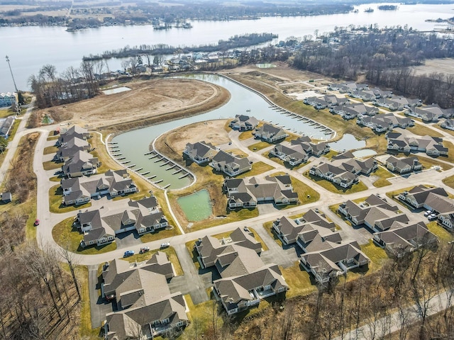 drone / aerial view with a residential view and a water view