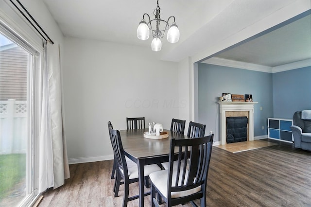 359 W Waterloo St, Canal Winchester, OH 43110 - dining area with wood finished floors, a chandelier, baseboards, a tile fireplace, and crown molding