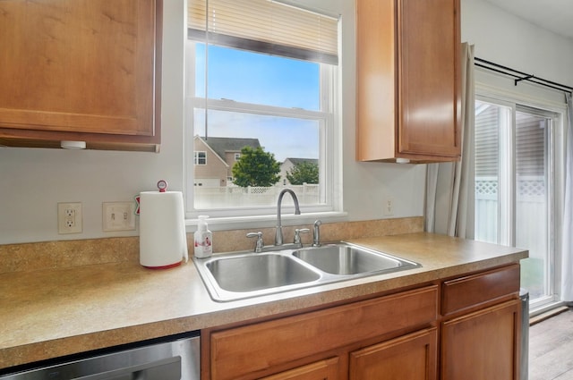 359 W Waterloo St, Canal Winchester, OH 43110 - kitchen featuring a sink, stainless steel dishwasher, light countertops, and brown cabinets