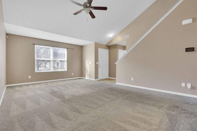 empty room with a ceiling fan, baseboards, visible vents, carpet floors, and vaulted ceiling