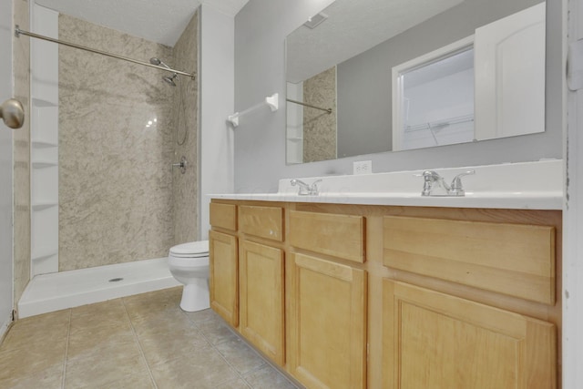 bathroom with double vanity, walk in shower, tile patterned flooring, a textured ceiling, and toilet