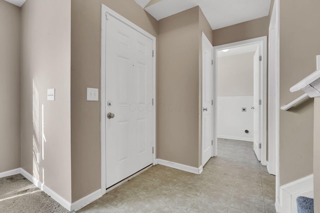 foyer with light tile patterned floors and baseboards