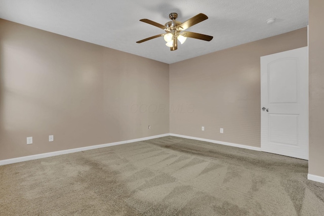 empty room with a ceiling fan, baseboards, and carpet floors