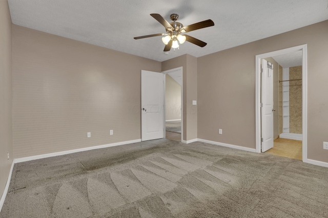 unfurnished bedroom with baseboards, carpet, and ceiling fan