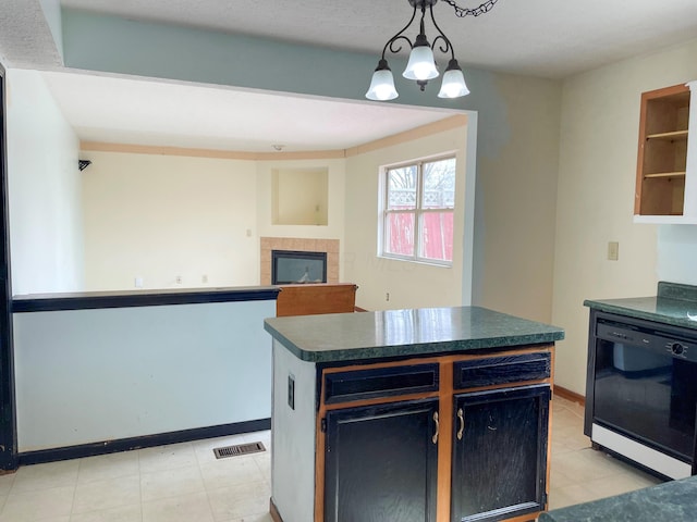 kitchen with visible vents, a kitchen island, pendant lighting, dishwasher, and dark countertops