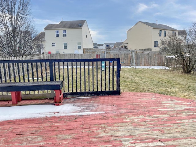 wooden terrace with a lawn and a fenced backyard