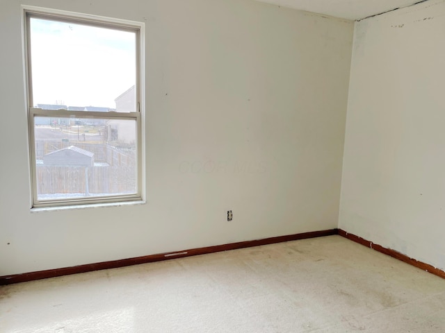 carpeted spare room with baseboards