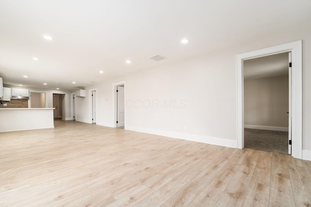 unfurnished living room with recessed lighting, visible vents, baseboards, and light wood-style flooring