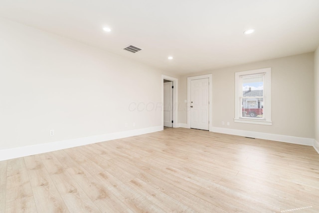 unfurnished room featuring recessed lighting, visible vents, light wood-style flooring, and baseboards