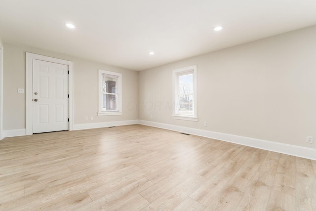 unfurnished room with recessed lighting, baseboards, and light wood-style floors