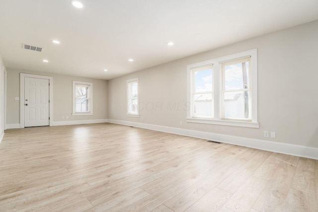 unfurnished room featuring recessed lighting, visible vents, and light wood finished floors