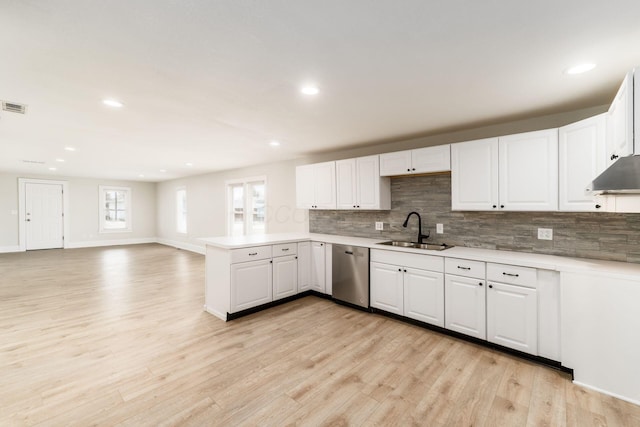 kitchen with a sink, light wood-style floors, dishwasher, and light countertops