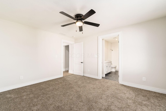 unfurnished bedroom with ceiling fan, baseboards, carpet floors, and ensuite bath