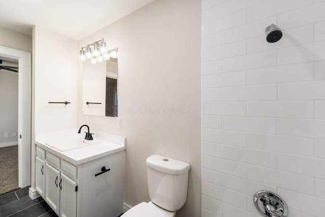 bathroom featuring toilet, vanity, and tile patterned flooring