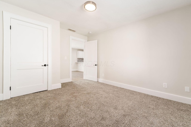 unfurnished bedroom with baseboards, visible vents, and carpet floors