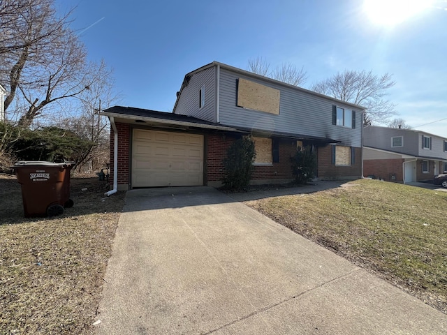 traditional-style home featuring a front lawn, an attached garage, brick siding, and driveway