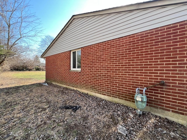 view of property exterior with brick siding