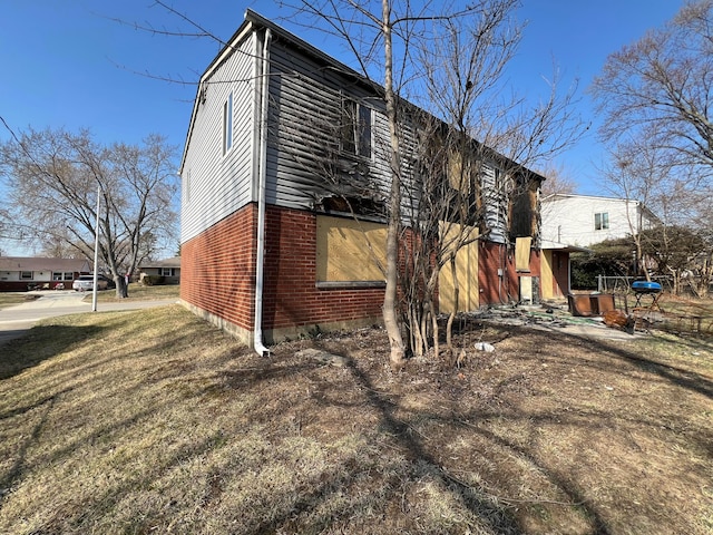 view of property exterior featuring brick siding