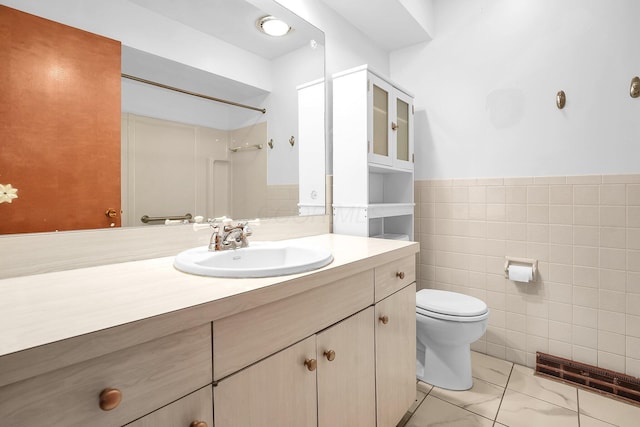 101 Cherokee Dr, Westerville, OH 43081 - bathroom featuring a shower, vanity, tile walls, toilet, and wainscoting