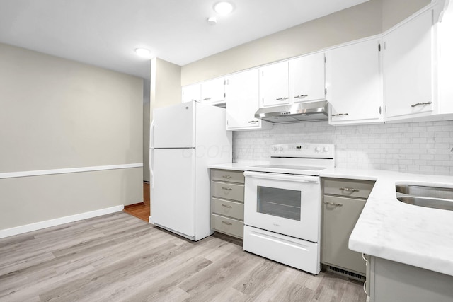 101 Cherokee Dr, Westerville, OH 43081 - kitchen featuring light countertops, light wood finished floors, white appliances, under cabinet range hood, and backsplash