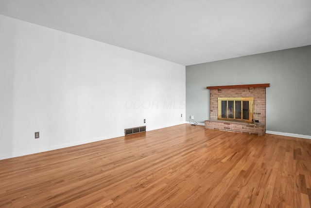 101 Cherokee Dr, Westerville, OH 43081 - unfurnished living room with a fireplace, visible vents, and wood finished floors