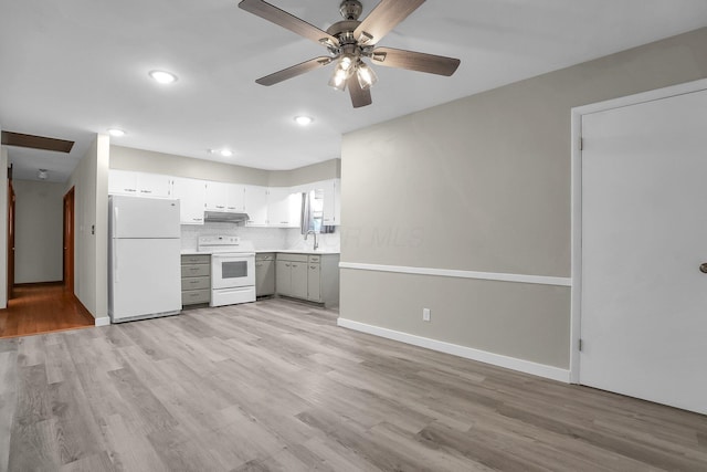 101 Cherokee Dr, Westerville, OH 43081 - kitchen featuring white appliances, under cabinet range hood, decorative backsplash, a sink, and light wood-style floors