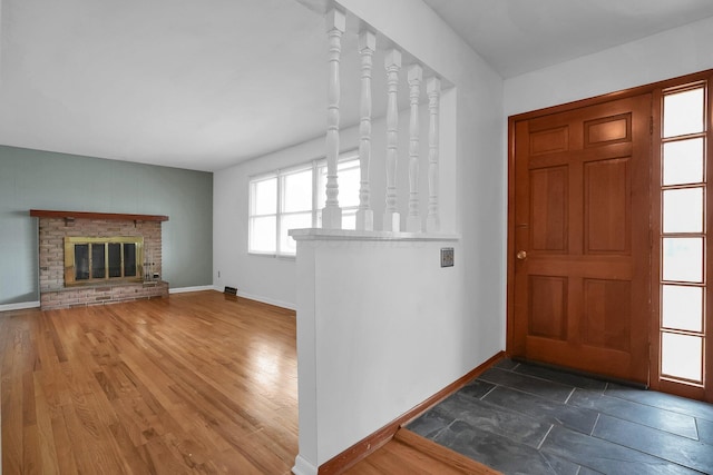 101 Cherokee Dr, Westerville, OH 43081 - foyer entrance with a brick fireplace, visible vents, baseboards, and dark wood finished floors