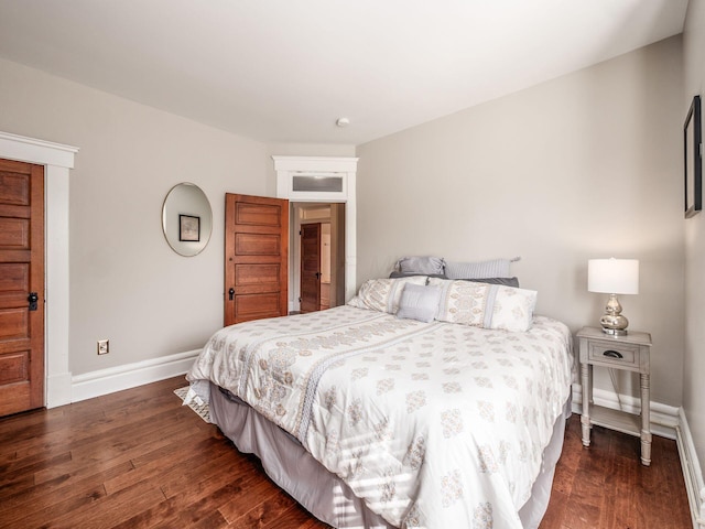 bedroom with baseboards and wood finished floors