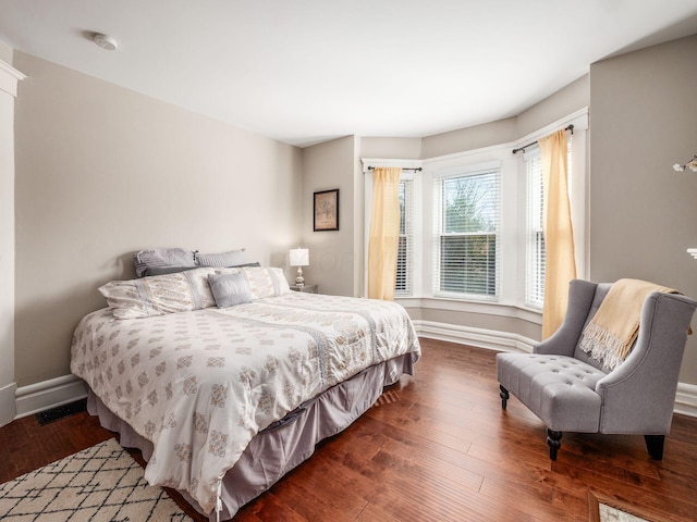 bedroom featuring baseboards and wood finished floors