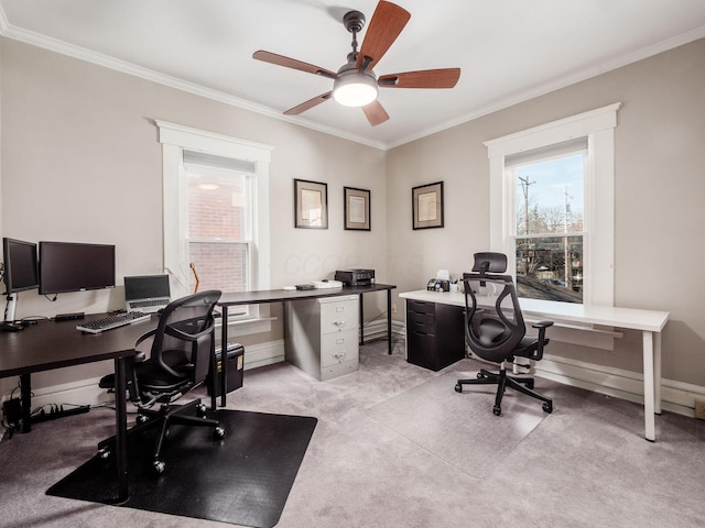 office featuring light carpet, baseboards, ceiling fan, and ornamental molding