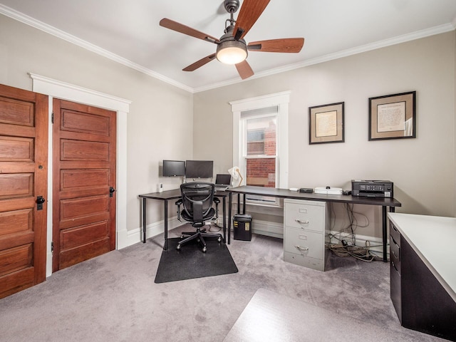 office space featuring carpet flooring, ceiling fan, crown molding, and baseboards